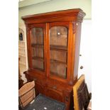 A VICTORIAN MAHOGANY FINISHED BOOKCASE UNIT the upper section having two arch topped glazed doors