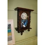 A SMALL SIZED VIENNESE STYLE HANGING WALL CLOCK