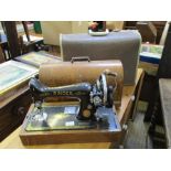 A WOODEN CASED SINGER MANUAL SEWING MACHINE together with another similar