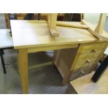 A MODERN OAK DESK UNIT with rectangular top having kneehole recess flanked by three graduated