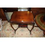 AN EARLY 20TH CENTURY MAHOGANY FINISHED FANCY SHAPED TABLE ON 'S' SHAPED LEGS UNITED BY AN UNDERTIER