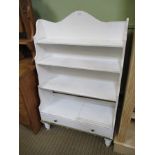A LATER PAINTED SET OF WATERFALL BOOKSHELVES with single full width drawer, supported on turned feet