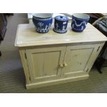 A SMALL MODERN WHITEWASH PINE TWO DOOR CUPBOARD