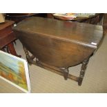 A 20TH CENTURY OAK OVAL TWIN FLAP DINING TABLE on turned & blocked legs with gateleg action