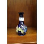 A SMALL MOORCROFT VASE with Queen Mary label attached to underside