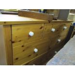 A MODERN PINE MULTI DRAWER CHEST with white ceramic handles