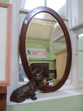 A MODEL SCOTTIE DOG together with a mahogany oval wall mirror