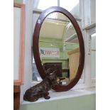A MODEL SCOTTIE DOG together with a mahogany oval wall mirror