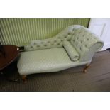 A MODERN SMALL SIZE CHAISE LONGUE with all over pale green patterned upholstery with bolster,