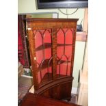 A WELL MADE REPRODUCTION MAHOGANY FINISHED CONCAVE CORNER CUPBOARD with bar glazed upper doors