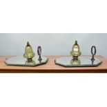 TWO MIRROR BACKED WALL LAMPS with glass reservoirs