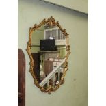 A GILT FRAMED FANCY SHAPED PLAIN PLATE WALL MIRROR