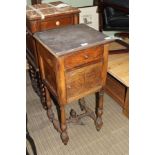 A 19TH CENTURY FRENCH OAK FINISHED BEDSIDE TABLE with slate insert top supported on fancy turned and