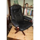 A MODERNIST SHOW WOOD FRAMED BLACK LEATHER EFFECT UPHOLSTERED MANUALLY RECLINING ARMCHAIR