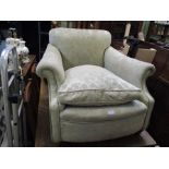 AN EARLY 20TH CENTURY FLOCK UPHOLSTERED DEEP SEATED ARMCHAIR