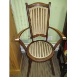 A LATE 19TH/EARLY 20TH CENTURY PENNY SEATED ARM CHAIR in the manner of Liberty's
