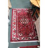 TWO RED GROUND WOVEN FLOOR CARPETS