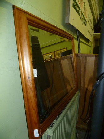 A PINE FRAMED RECTANGULAR BEVEL PLATE WALL MIRROR