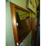 A PINE FRAMED RECTANGULAR BEVEL PLATE WALL MIRROR