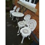 A SELECTION OF PAINTED METAL GARDEN FURNITURE comprising four chairs and a table finished in white