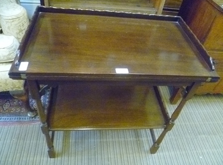 A 20TH CENTURY MAHOGANY FINISHED SWIVEL TOPPED CARD TABLE on turned and blocked legs with a plain