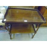 A 20TH CENTURY MAHOGANY FINISHED SWIVEL TOPPED CARD TABLE on turned and blocked legs with a plain