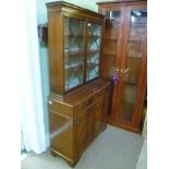 A SMALL PROPORTION REPRODUCTION MAHOGANY FINISHED BOOKCASE UNIT with astragal glazed upper section