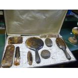 A CASED DECORATIVE HORN EFFECT DRESSING TABLE SET
