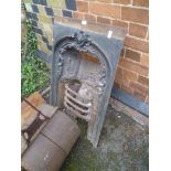 A CAST IRON FIRE SURROUND with integral grate