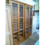 A PAIR OF CRAFTSMAN BUILT PINE FRAMED TWO DOOR SHOE CABINETS with railed interior