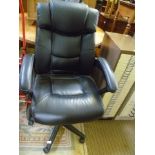 A BLACK LEATHER EFFECT UPHOLSTERED EXECUTIVE ARMCHAIR
