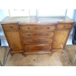 A REPRODUCTION MAHOGANY BREAKFRONT SMALL SIZED SIDE UNIT having four graduated central drawers,