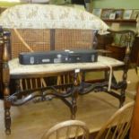 A FIRST QUARTER 20TH CENTURY TURNED BEECH FRAMED BERGERE BACKED TWO PERSON SETTEE