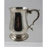 W** & *T A GEORGE I SILVER PINT MUG having caulked rim and plain baluster body with scrolled handle,