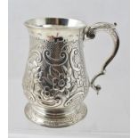 A GEORGE II ONE PINT SILVER MUG of traditional baluster form with acanthus scrolled handle and