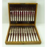 A LATE VICTORIAN OAK CASE OF SILVER PLATED DESSERT KNIVES AND FORKS, for twelve