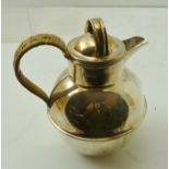 A SILVER "JERSEY" MILK JUG having wicker whipped handle, detachable lid and ringed body,