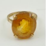 A 9CT GOLD LADY'S DRESS RING set with an oval facet cut citrine, size M and half