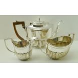 A SILVER PLATED THREE PIECE TEA SET OF GEORGIAN DESIGN, oval fluted form, comprising teapot, milk