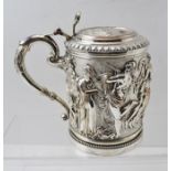 A VICTORIAN ELECTRO PLATE ON COPPER TANKARD having allover ornate repousse work decoration with