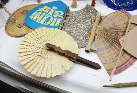 A COLLECTION OF INDIAN FANS (PANKHA) includes two peacock feather examples, an embossed white - Image 2 of 5