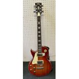 A LEFT HANDED VINTAGE BRAND SUNBURST "LES PAUL" DESIGN GUITAR with strap