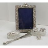 A COLLECTION OF SILVER ITEMS comprising; an Edwardian silver mounted cut glass dressing table box,
