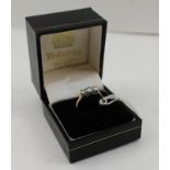 A THREE STONE DIAMOND RING, brilliant cut, in an 18ct and platinum set, ring size "K"