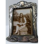 AN EDWARDIAN SILVER MOUNTED PHOTOGRAPH FRAME of Art Nouveau design, Birmingham 1901, to take an