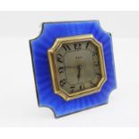 AN ART DECO DESIGN TRAVEL CLOCK, with blue guilloche enamel frame, 8 days movement, silvered dial