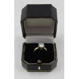 A SOLITAIRE MOISSANITE RING, the brilliant cut stone mounted on an 18ct gold band, ring size K and