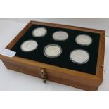 A COLLECTION OF TWENTY-TWO SILVER ROYAL MINT COLLECTOR'S COINS, produced in arrangement with The
