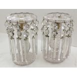 A PAIR OF VICTORIAN CLEAR GLASS CANDLE LUSTRES, the bowl tops with brass candle nozzles, from the