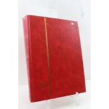 A STOCKBOOK (red) containing many hundreds of WORLD STAMPS, good variation